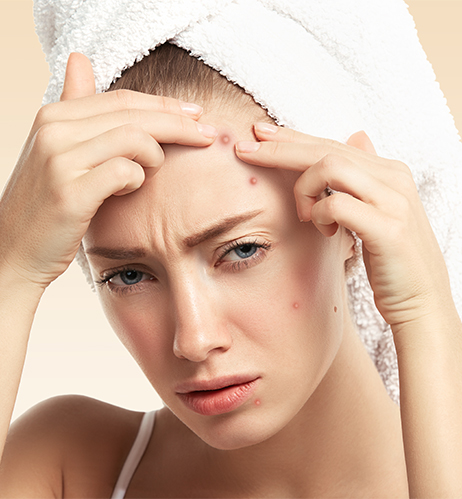 Dermatology clinician examining a patient’s facial acne in a treatment room